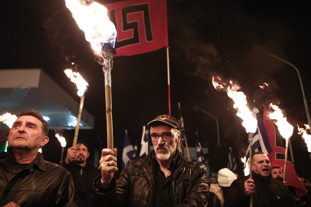 Golden Dawn supporters hold lit torches during a far-right rally in Athens on Feb. 3, 2018 (Nick Paleologos)