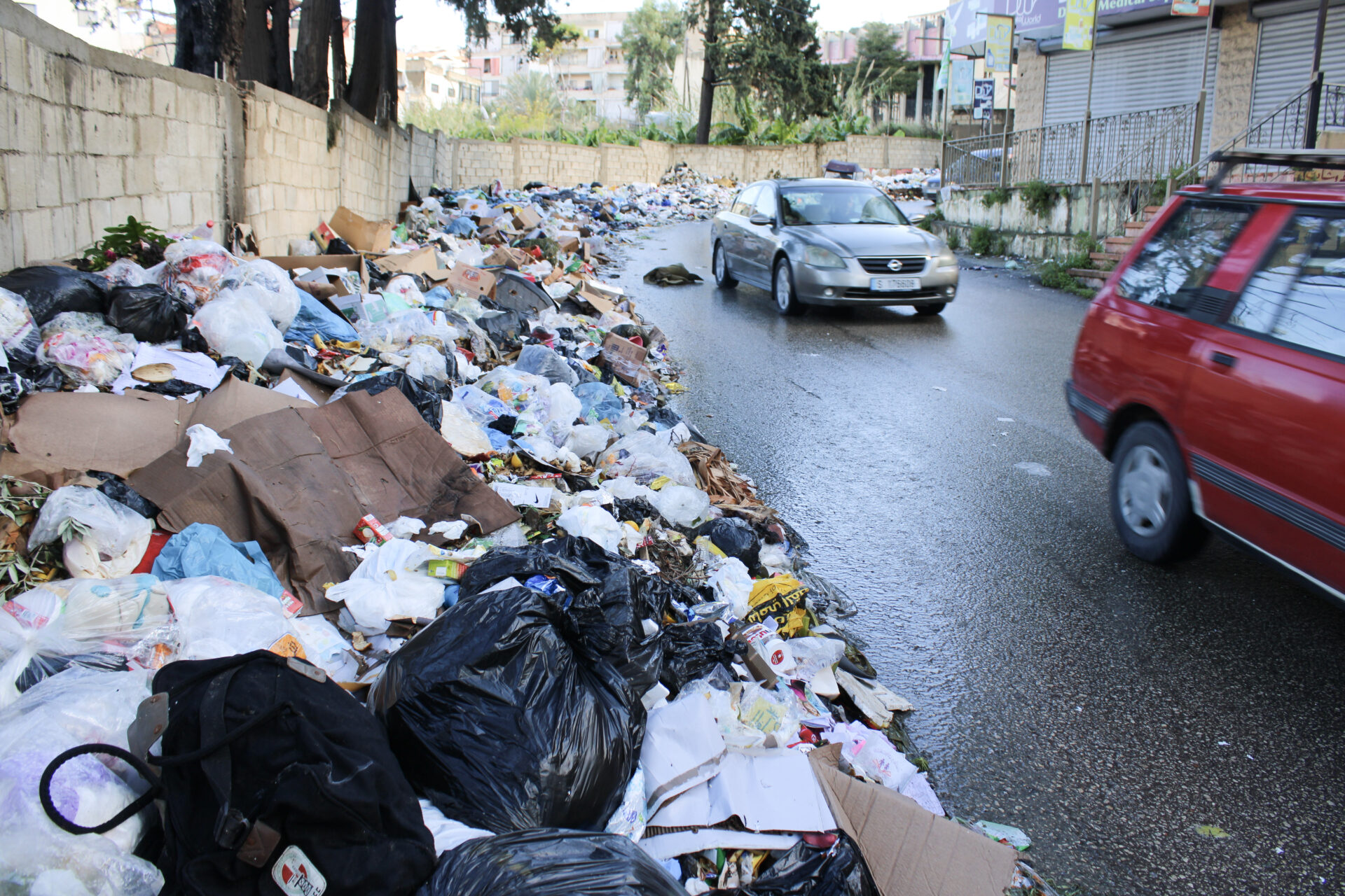 Trash piles high along the street in Saida (Hanna Davis)
