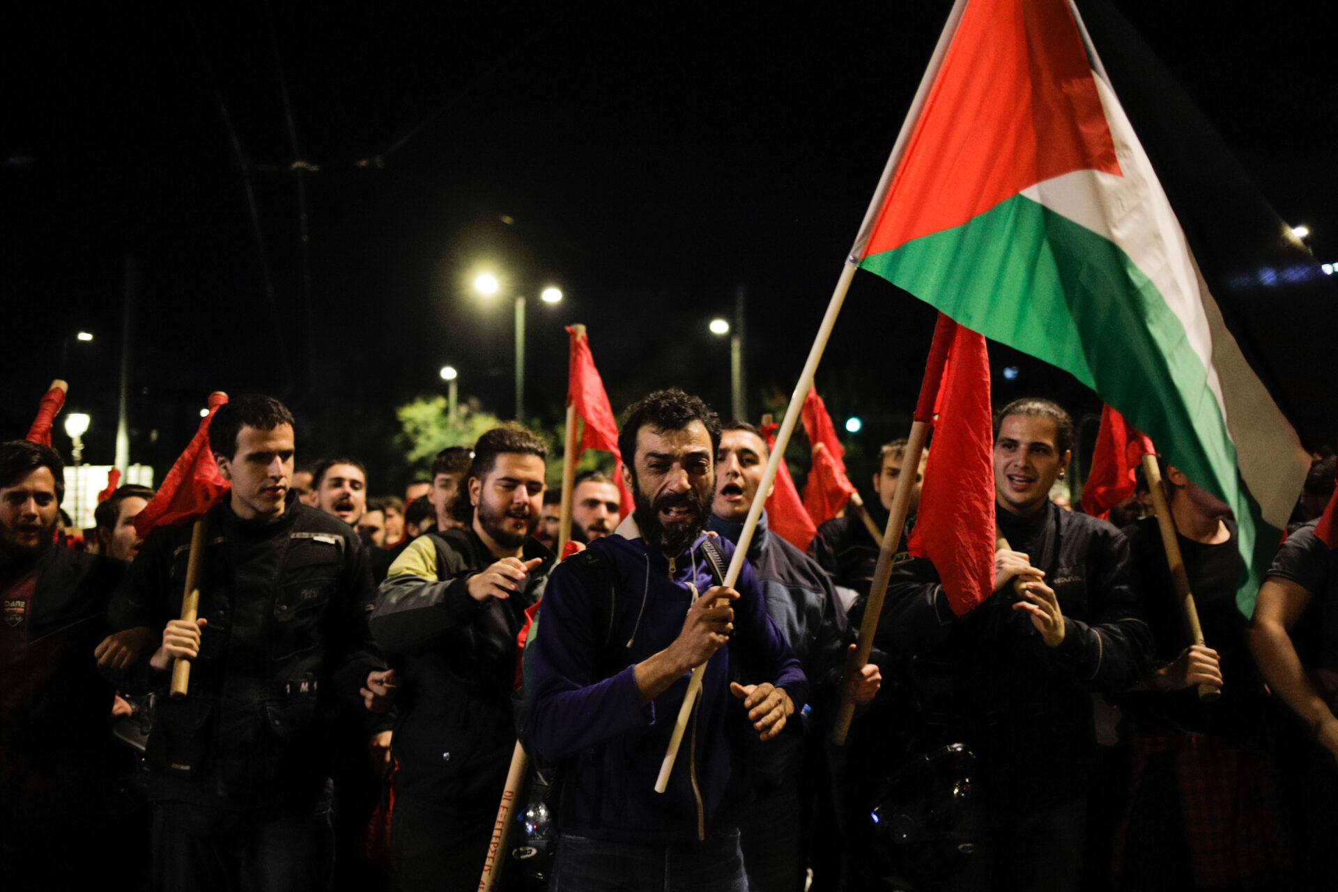 A demonstrator holds the Palestinian flag during an annual march to commemorate the Athens Polytechnic Uprising in Greece on Nov. 17, 2023 (Victoras Antonopoulos)