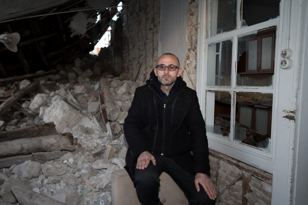 Yalçin Yalçinkaya sits near the remains of the living room where he used to spend much of his time (Kyriakos Finas)