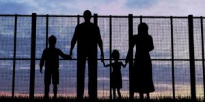 Silhouette of a refugees family with children
