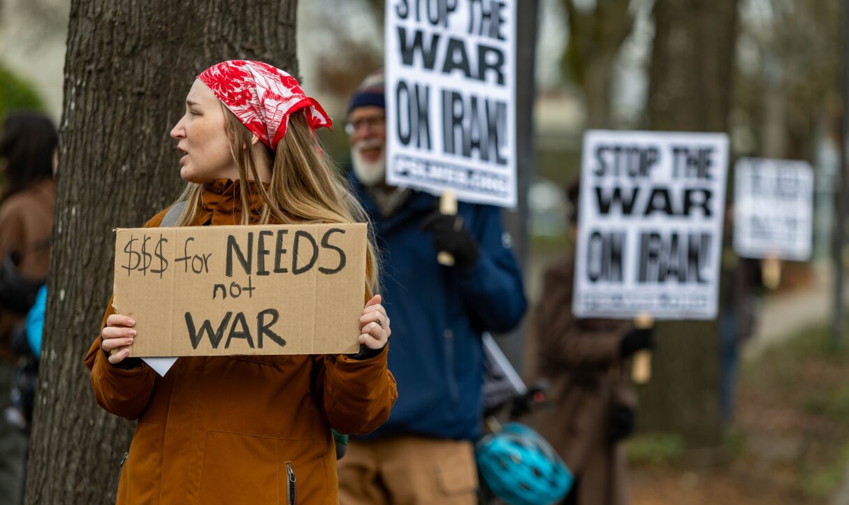 Demonstrators in Eugene, Oregon, rally against the Trump administration's war in Iran in February 2026 (David Geitgey Sierralupe/Wikimedia Commons)