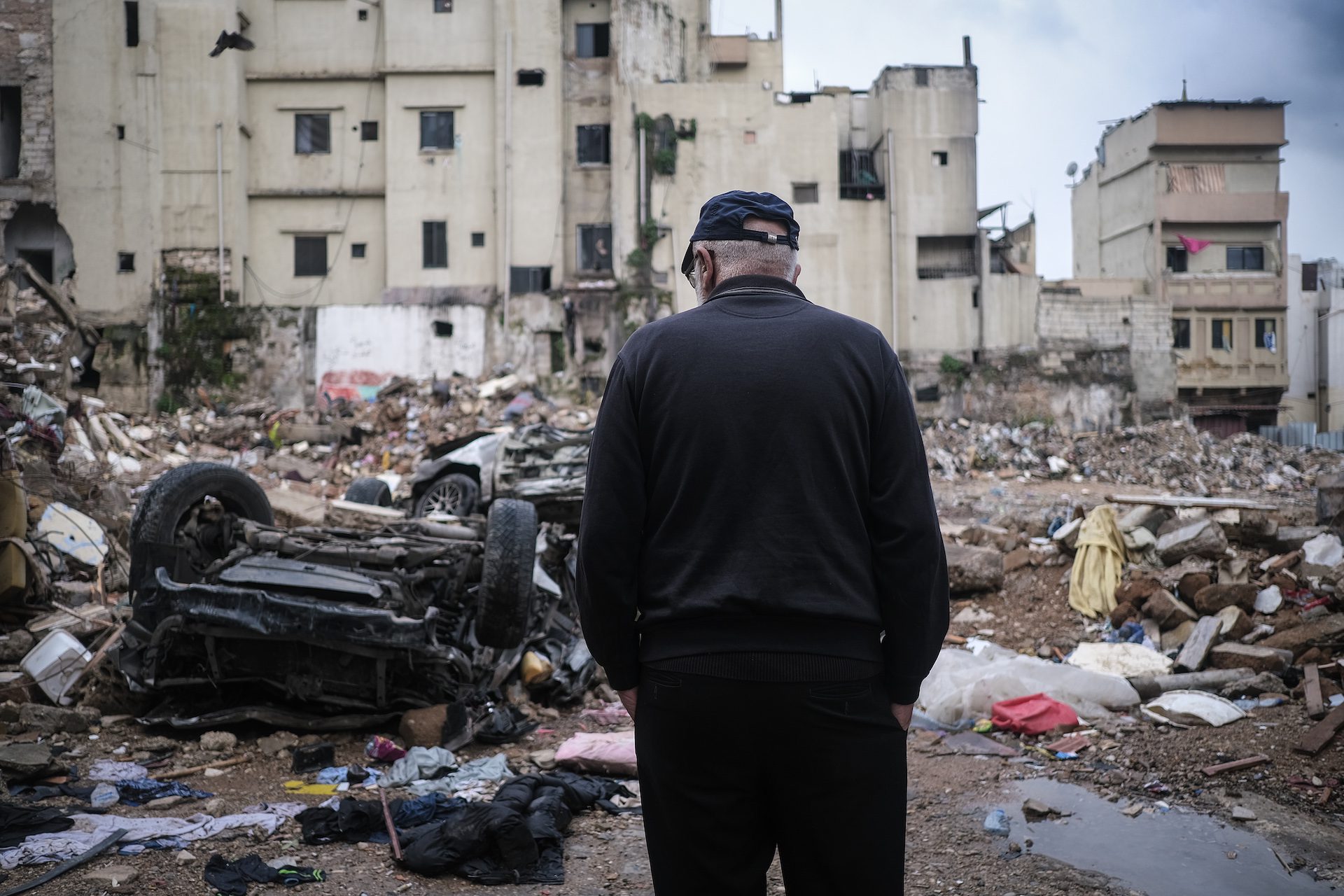 A man looks at the wreckage of a recent building collapse in Tripoli, Lebanon, in February 2026 (João Sousa)