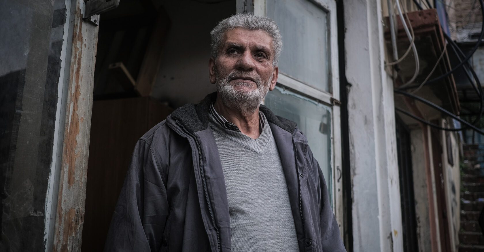 A man stands in a doorway in Tripoli, Lebanon, after a recent building collapse (João Sousa)