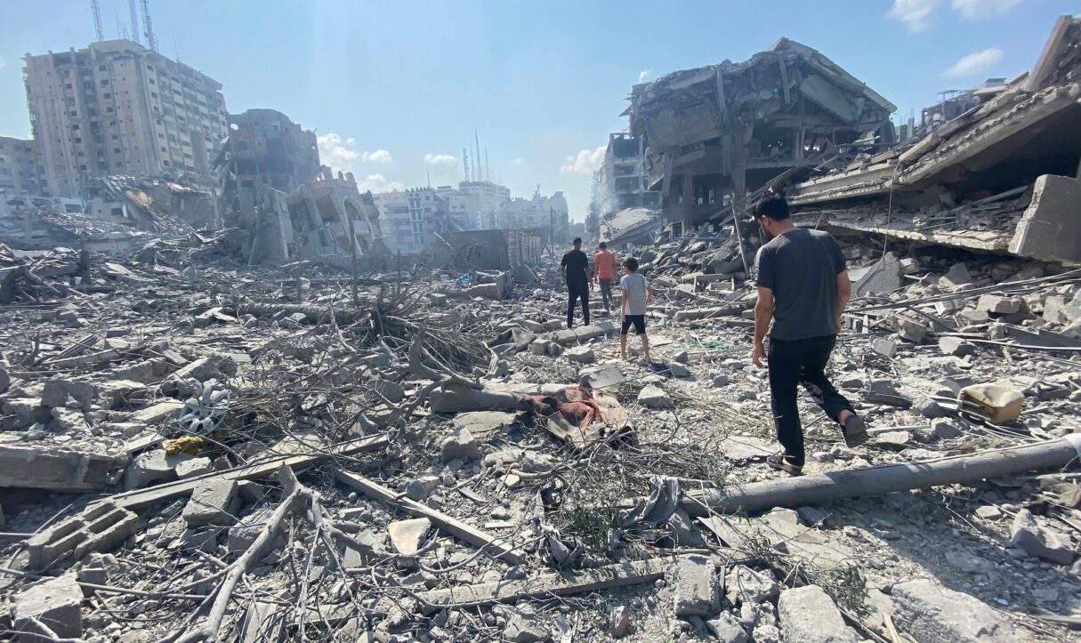 Palestinians inspect damage after an Israeli airstrike on the Remal area of Gaza City on Oct. 9, 2023 (WAFA via Wikimedia Commons)