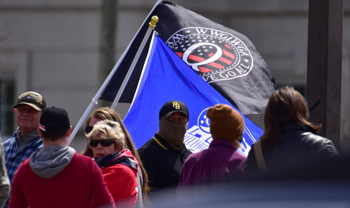 A photo shows participants near a QAnon flag during the World Wide Rally in Raleigh in March 2021 (Anthony Crider/Wikimedia Commons)