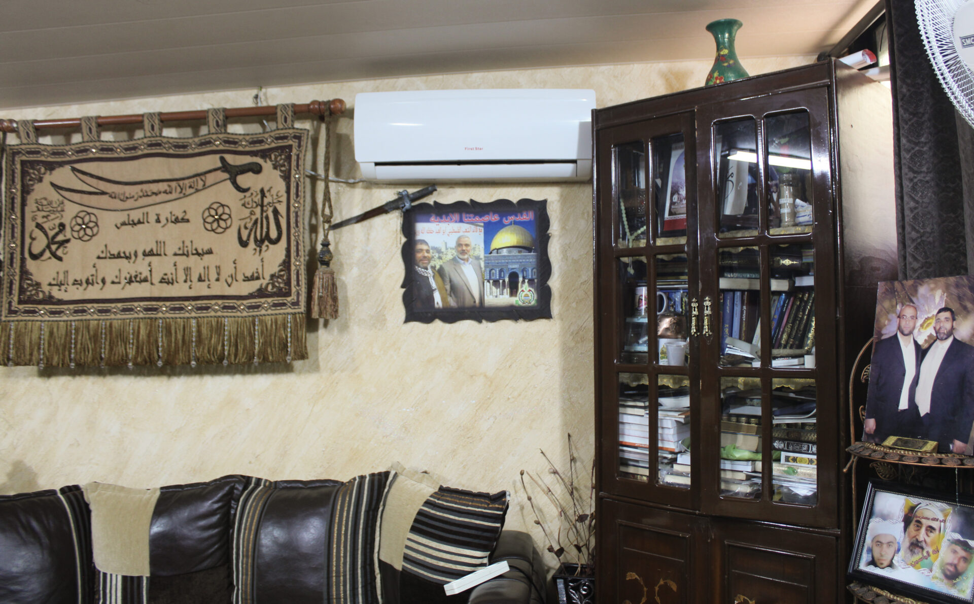 In Saida, local Hamas leader Abu Abed Shanaa's living room is decorated with photos with party brass (Hanna Davis)