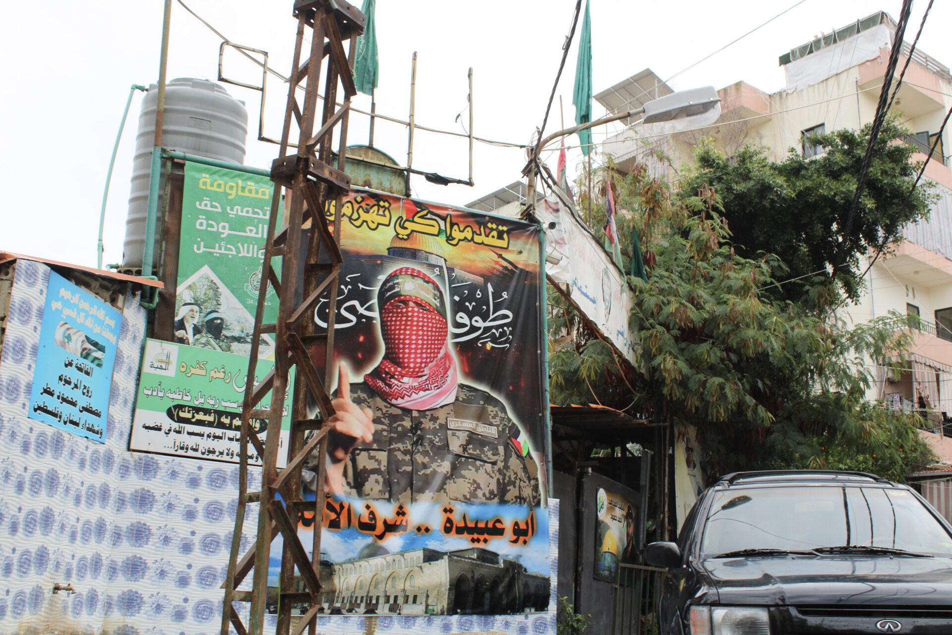In one neighborhood in Saida, a poster depicts Abu Obeida, the spokesperson of Hamas's military wing (Hanna Davis)