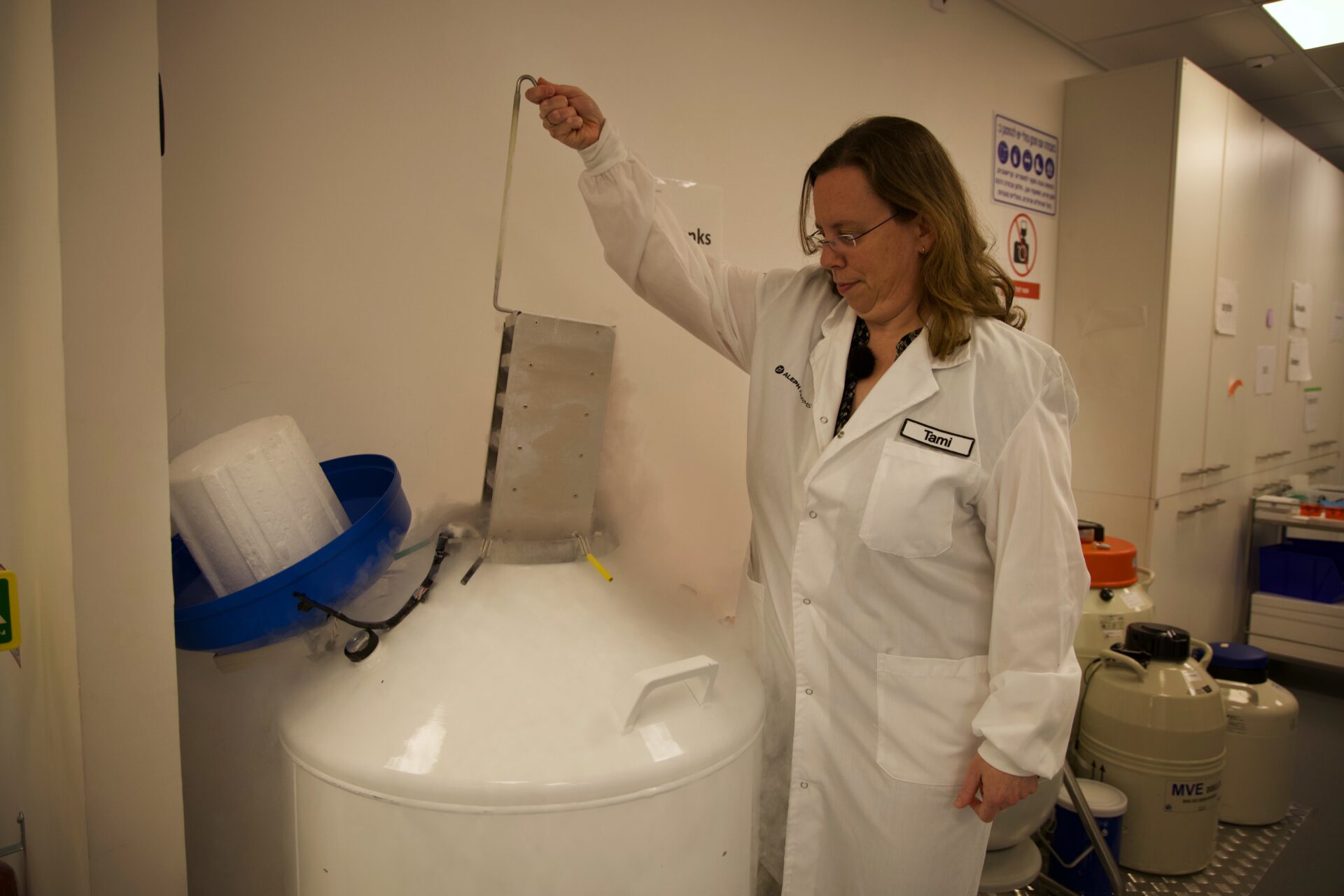 Aleph's vice president of R&D Tami Dvash extracting a container of cow cells (Hannah McCarthy via Inkstick)