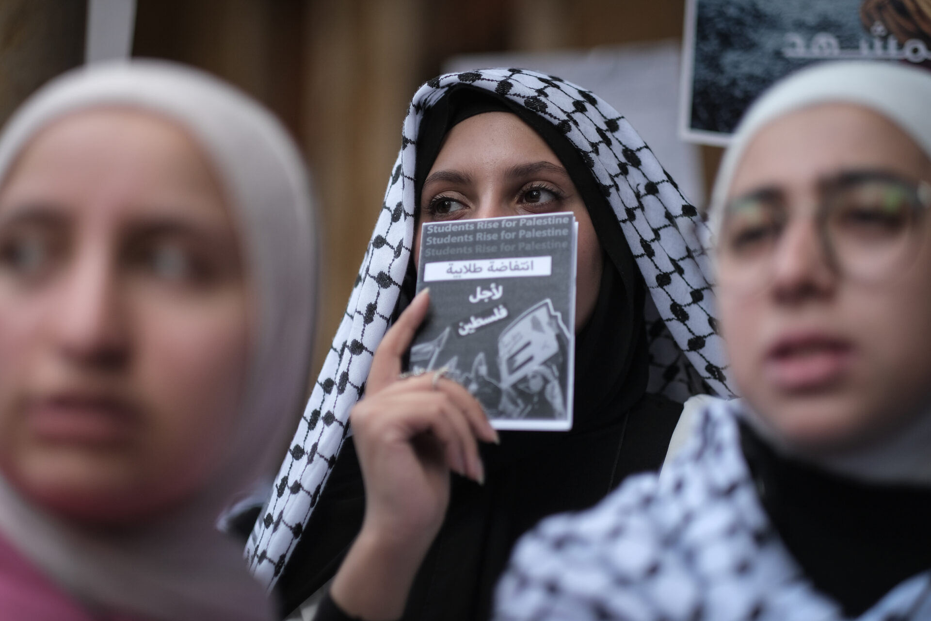 A student holds up a pamphlet of protesters’ demands during a protest on the American University of Beirut campus, May 7, 2024 (João Sousa)