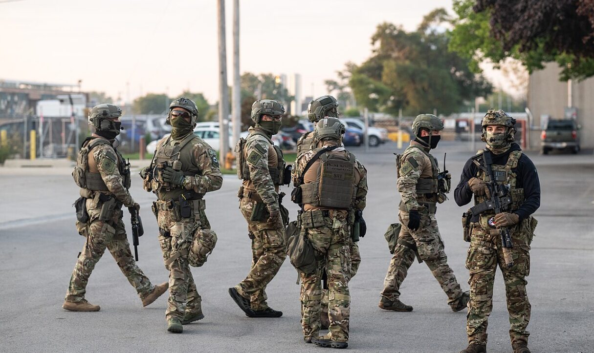 Law enforcement officers stand by during a protest against ICE in Chicago in September 2025 (Paul Goyette/Wikimedia Commons)