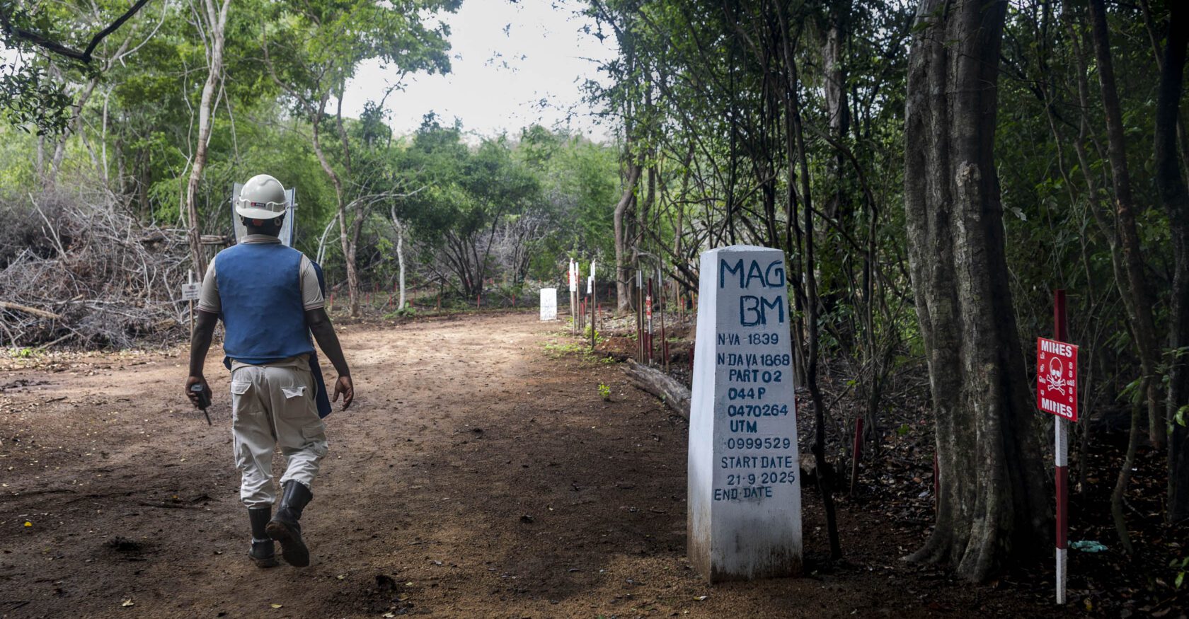 A sign at the entrance of a minefield in Sri Lanka's Vavuniya District announces details of mine-clearing operations (Dimitra Margariti)