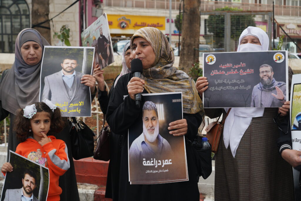 Iman Barghouti on Al Manarah Square in Ramallah on Nov. 15, 2023, holding a picture of Omar Daragmeh, who died in the Israeli prison of Majidol in October 2023.
