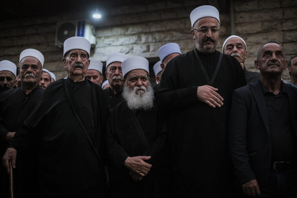 Baysour mayor Nadim Malaeb (far right) stands shoulder-to-shoulder with the Aridi family’s head sheikh, Sheikh Kamel Aridi, at the annual Liqaa al-Eid ceremony in the town square (João Sousa)