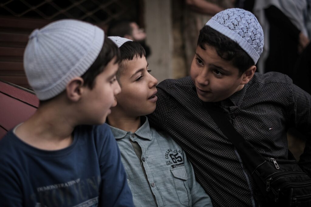 Boys gather in Baysour’s main square for the annual Liqaa al-Eid ceremony marking Eid al-Adha on June 16, 2024 (João Sousa)