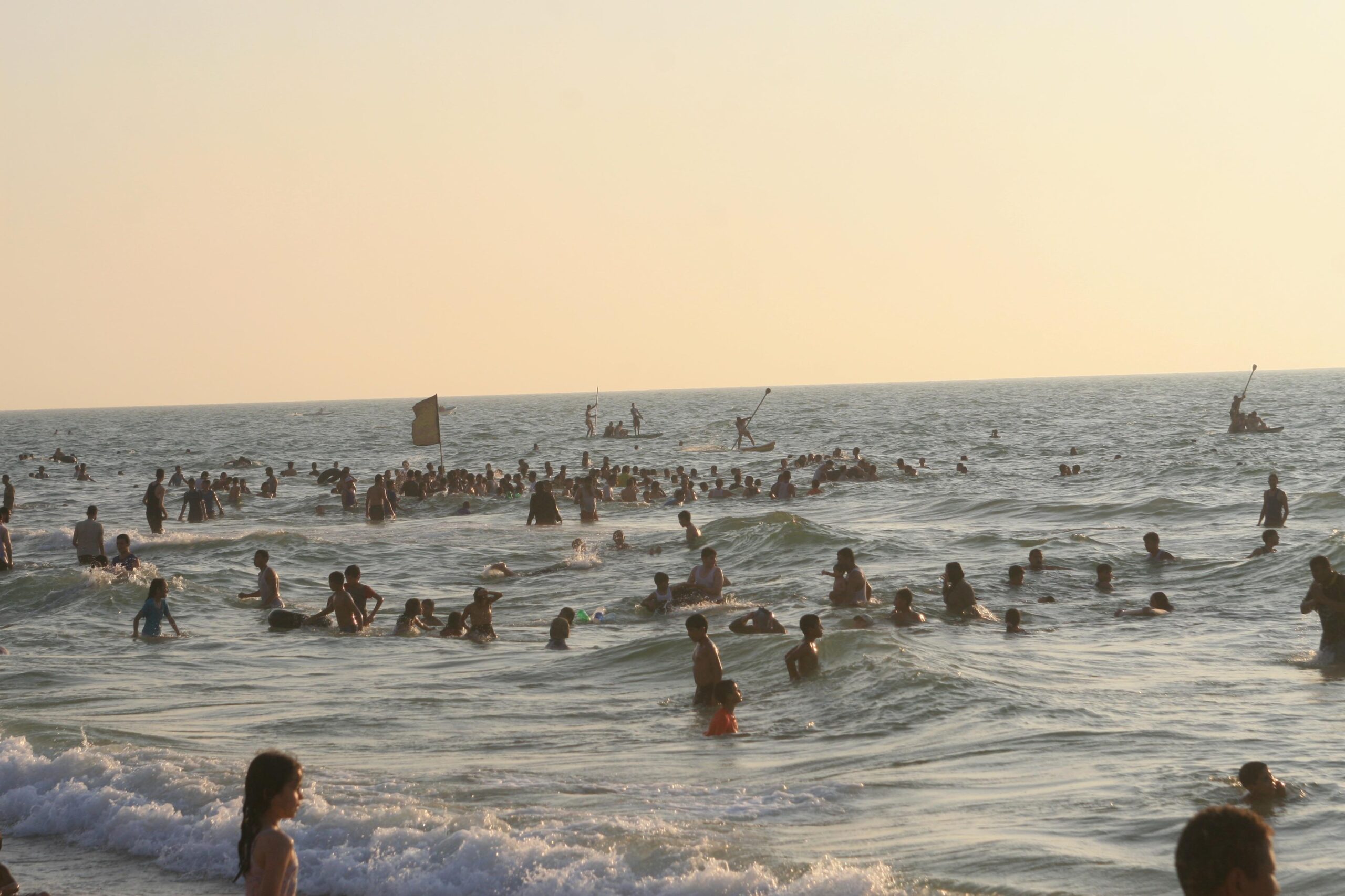 Palestinians, families and children alike, take a dip in the sea off Gaza’s coast (Mohammed Omer Almaghayer)