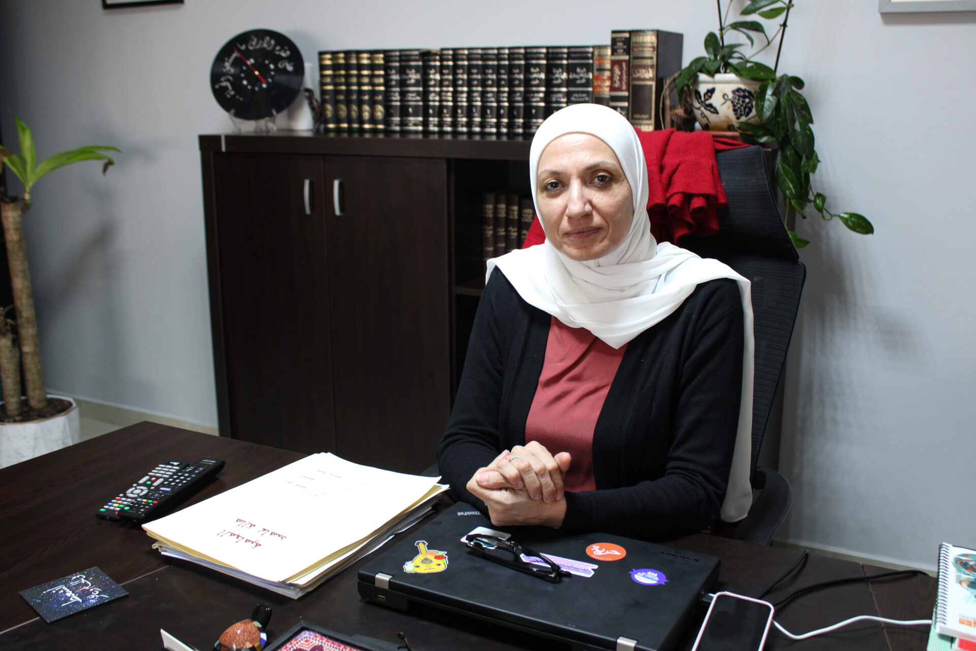 Human rights lawyer Hala Ahed in her office in Amman, the files of her detained clients are stacked beside her (Hanna Davis)