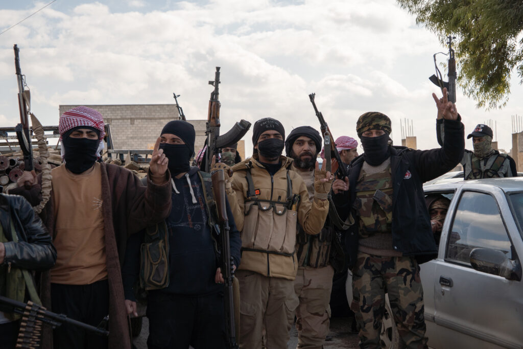 Armed tribesmen gather near the western bank of the Euphrates River on Jan. 19, 2026 (Anagha Subhash Nair)