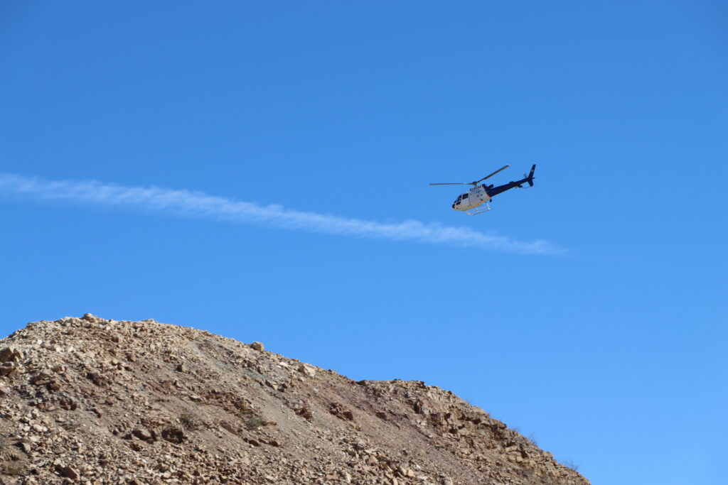 A helicopter flies over the mountainous borderlands on the US boundary with Mexico (Johannes Streeck)