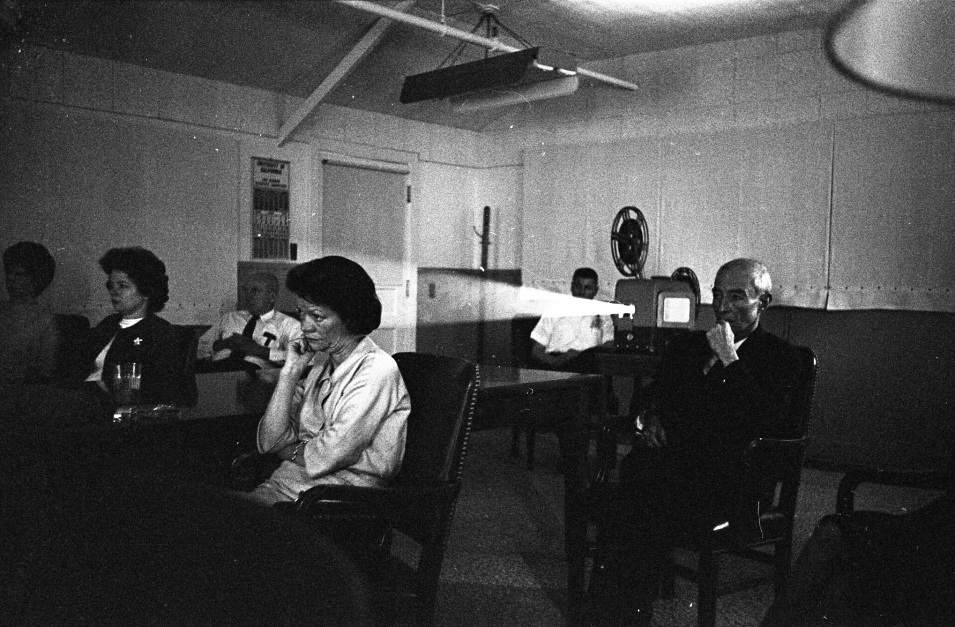 First Director of the Laboratory at Los Alamos (LANL’s original name) J. Robert Oppenheimer (right) watching the documentary, “Ten Seconds that Shook the World” with his wife, Kitty Oppenheimer (center) during their visit to the Lab in May 1964. May 18, 1964 LA-UR-23-23467 Image Number: PUB 5829-117; 21-00005366