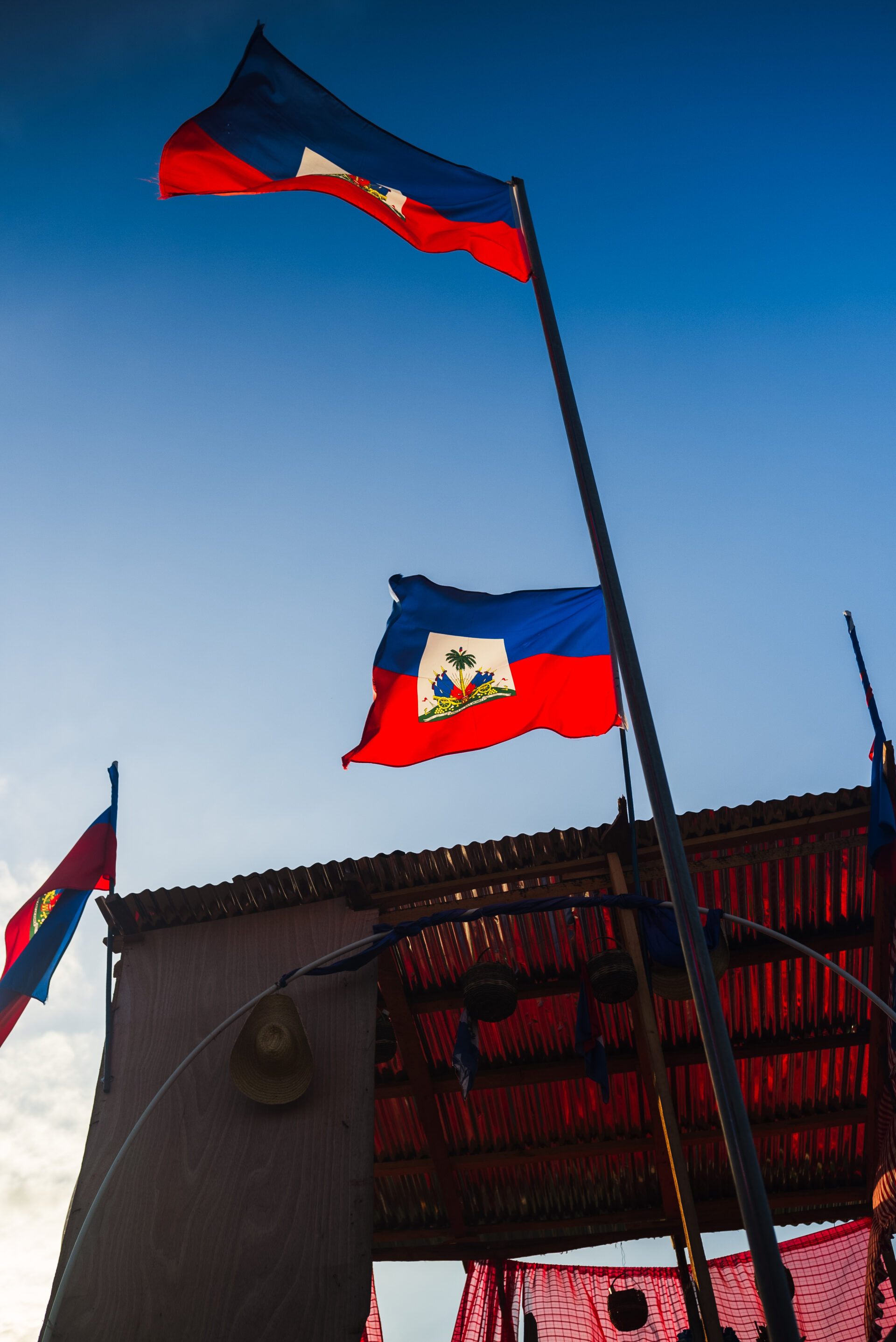 Haitian flags fly near the construction of the canal in Ouanaminthe.
