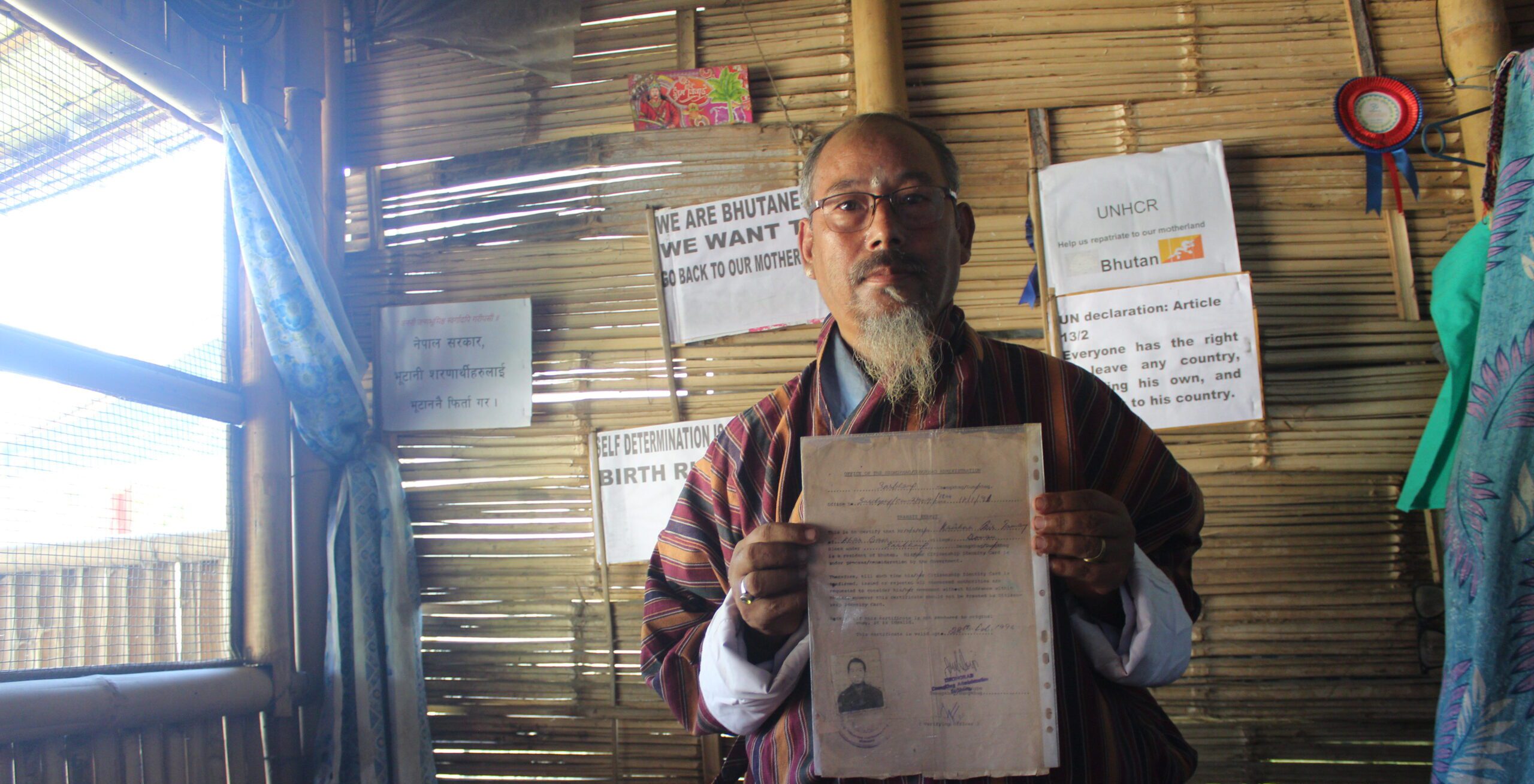 Krishnabir displays his Bhutanese documents