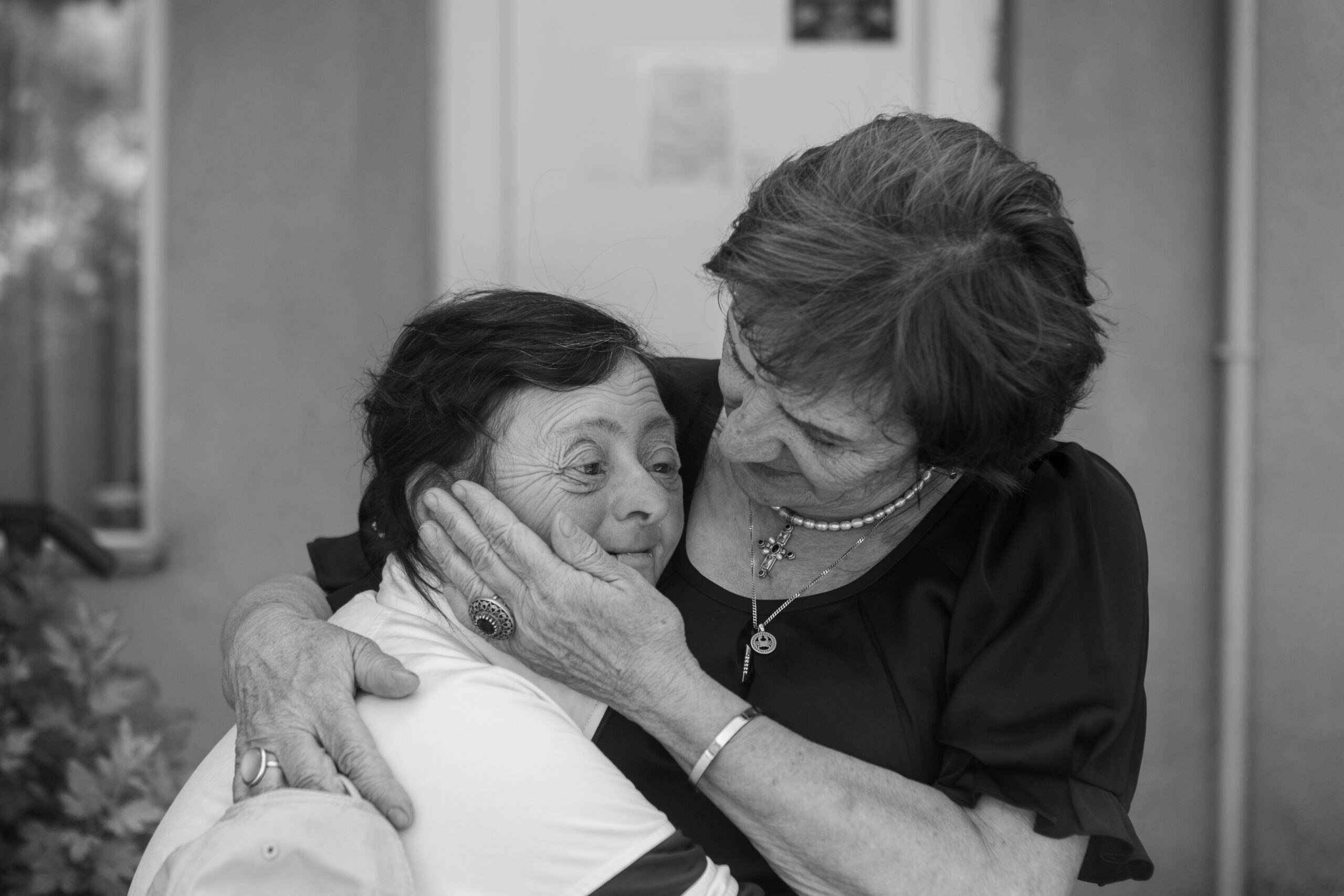 Luda Salia hugs one of the member of shelter. Khurvaleti. Georgia. 2023