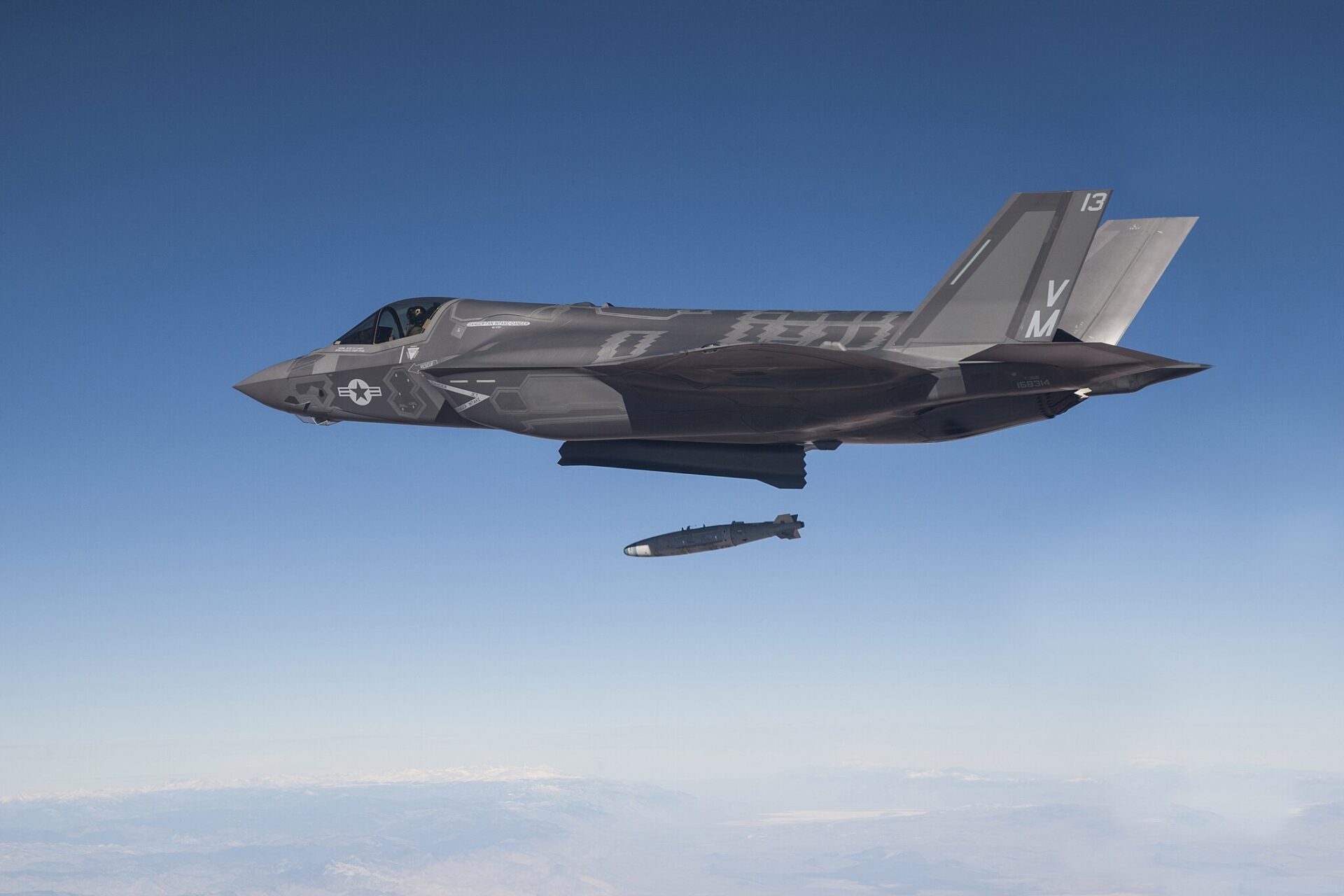 An F-35B Joint Strike Fighter test aircraft piloted by Marine Corps Lt. Col. Jon "Miles" Ohman drops a GBU-32 guided munition during a live-fire weapons delivery test at Edwards Air Force Base, California (Tom Reynolds, U.S. Navy photo courtesy of Lockheed Martin)