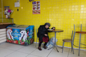 An elderly resident of Kramatorsk inside a cafe. March 2025.