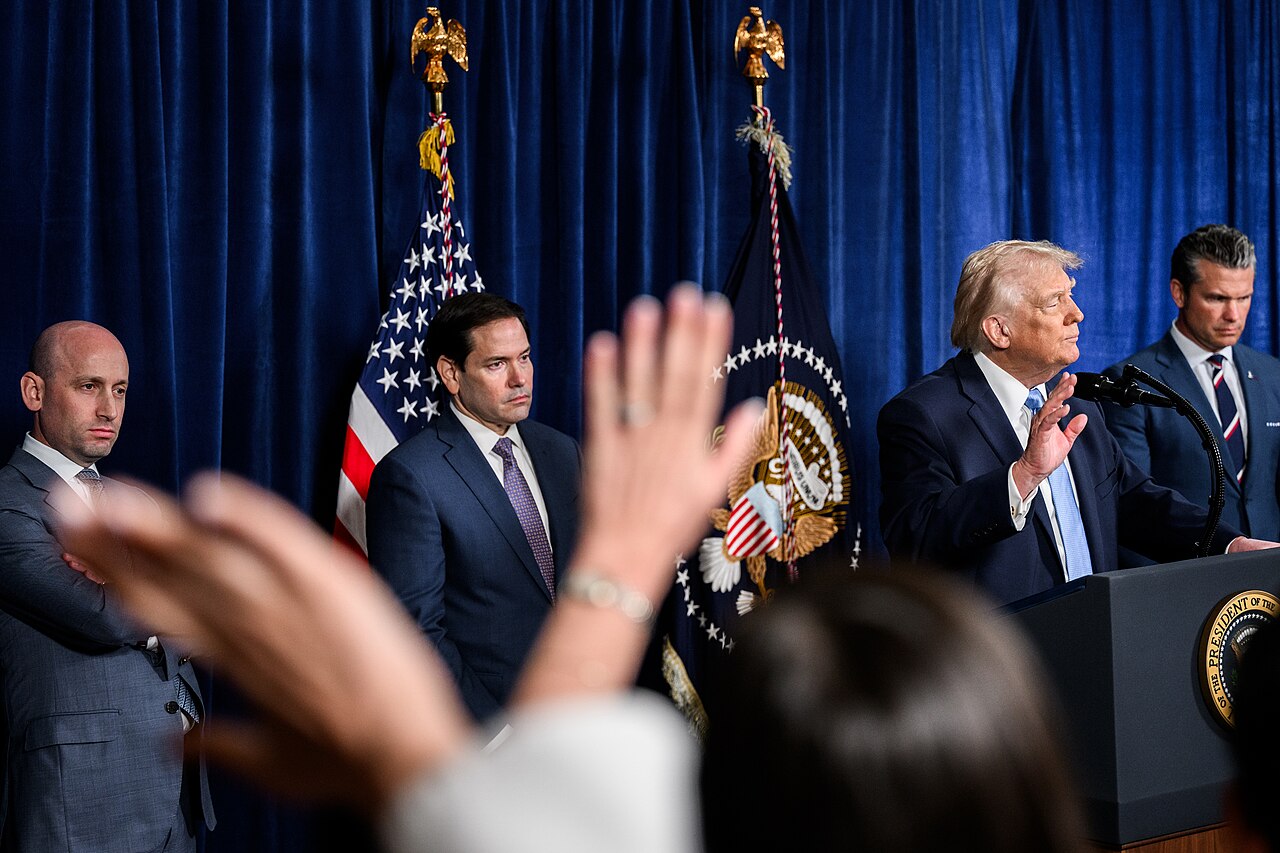 Stephen Miller, Marco Rubio, Donald Trump, and Pete Hegset at a press conference at Mar-a-Lago in January 2026 (Molly Riley/White House/Wikimedia Commons)
