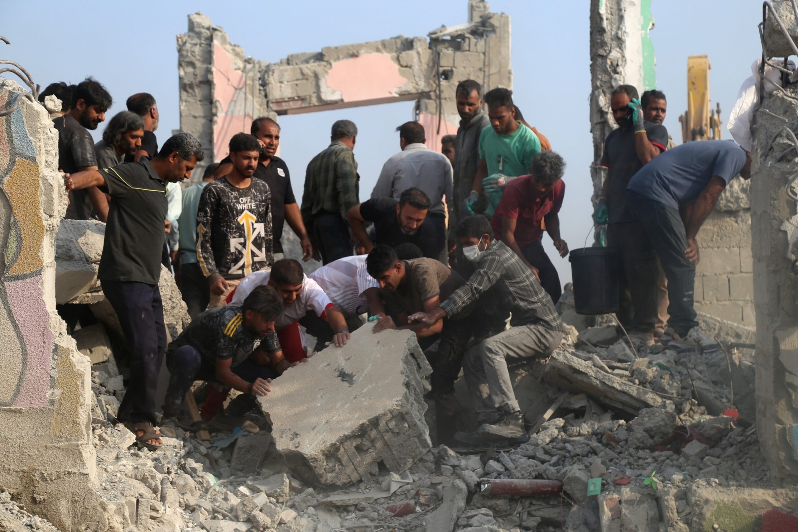 A photo shows civilians digging through the wreckage of a strike on an Iranian primary school in Minab (Abbas Zakeri/Mehr News Agency/Wikimedia Commons)