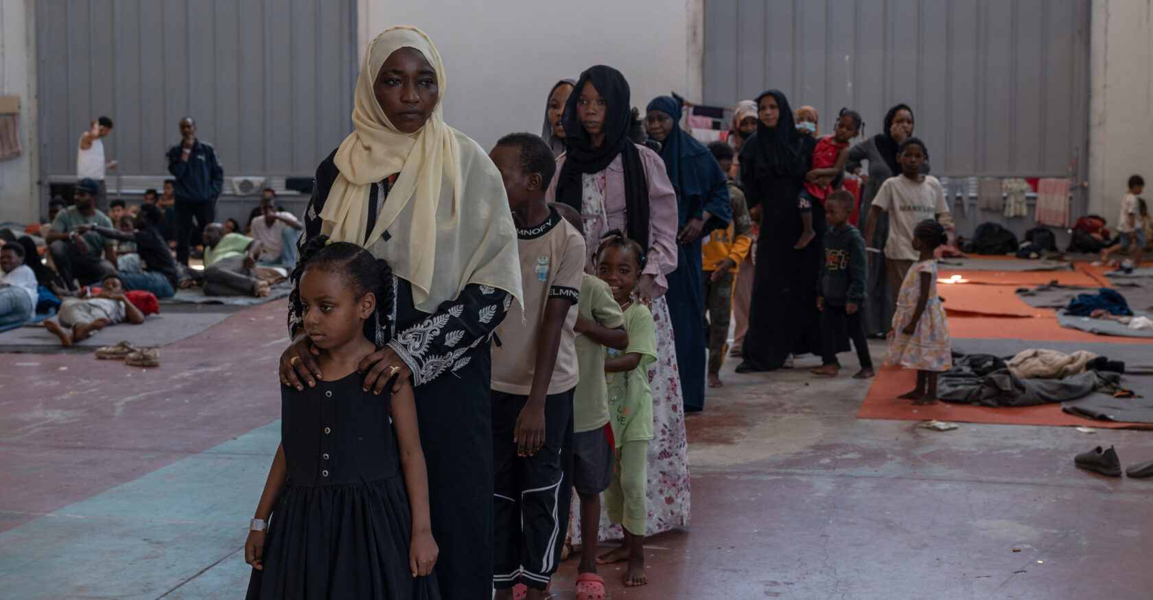Women line up in a queue inside a refugee facility in Crete (Dimitra Margariti)