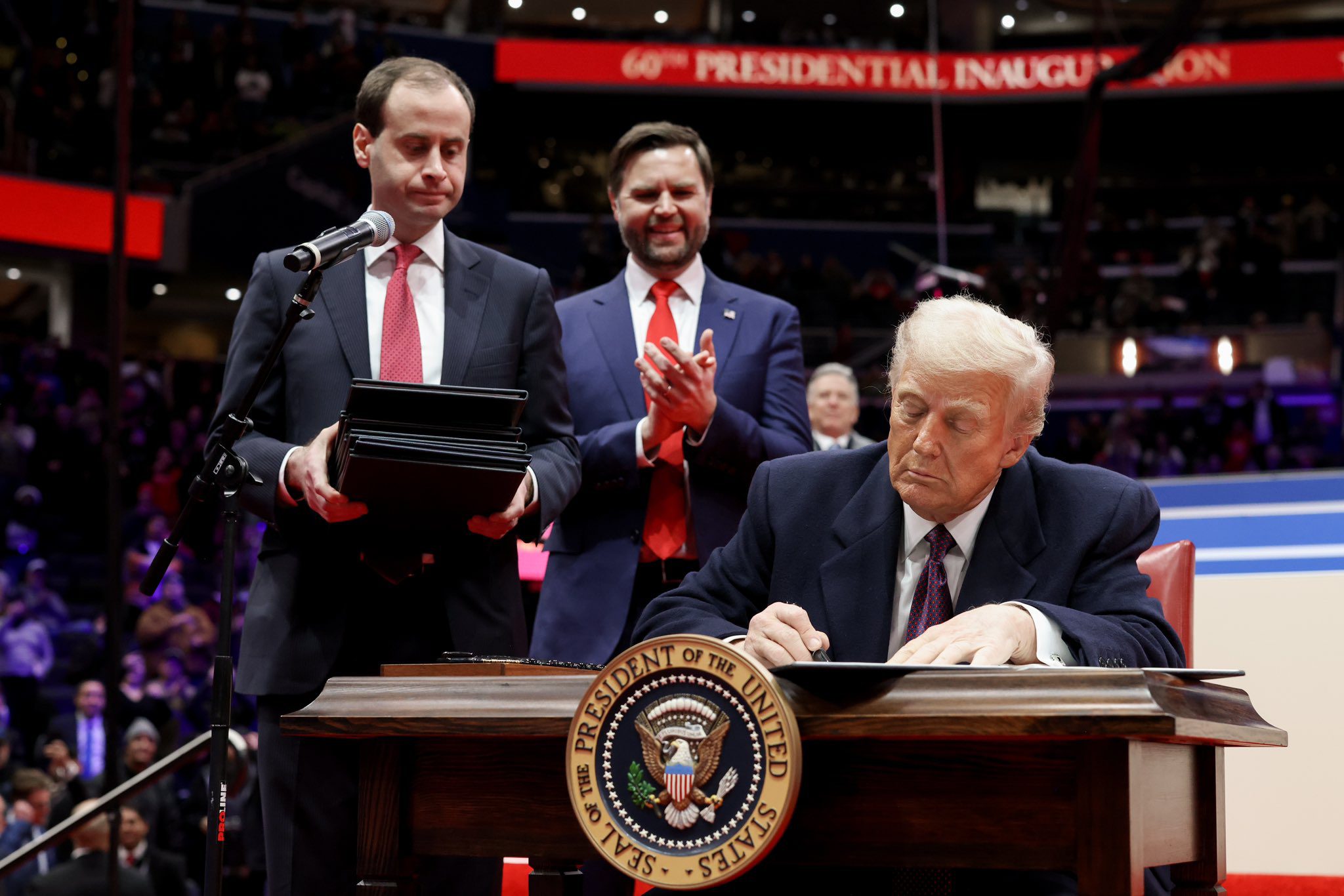 Donald Trump signing executive orders on the first day of his second term, in January 2025 (Vice President's Office/Wikimedia Commons)