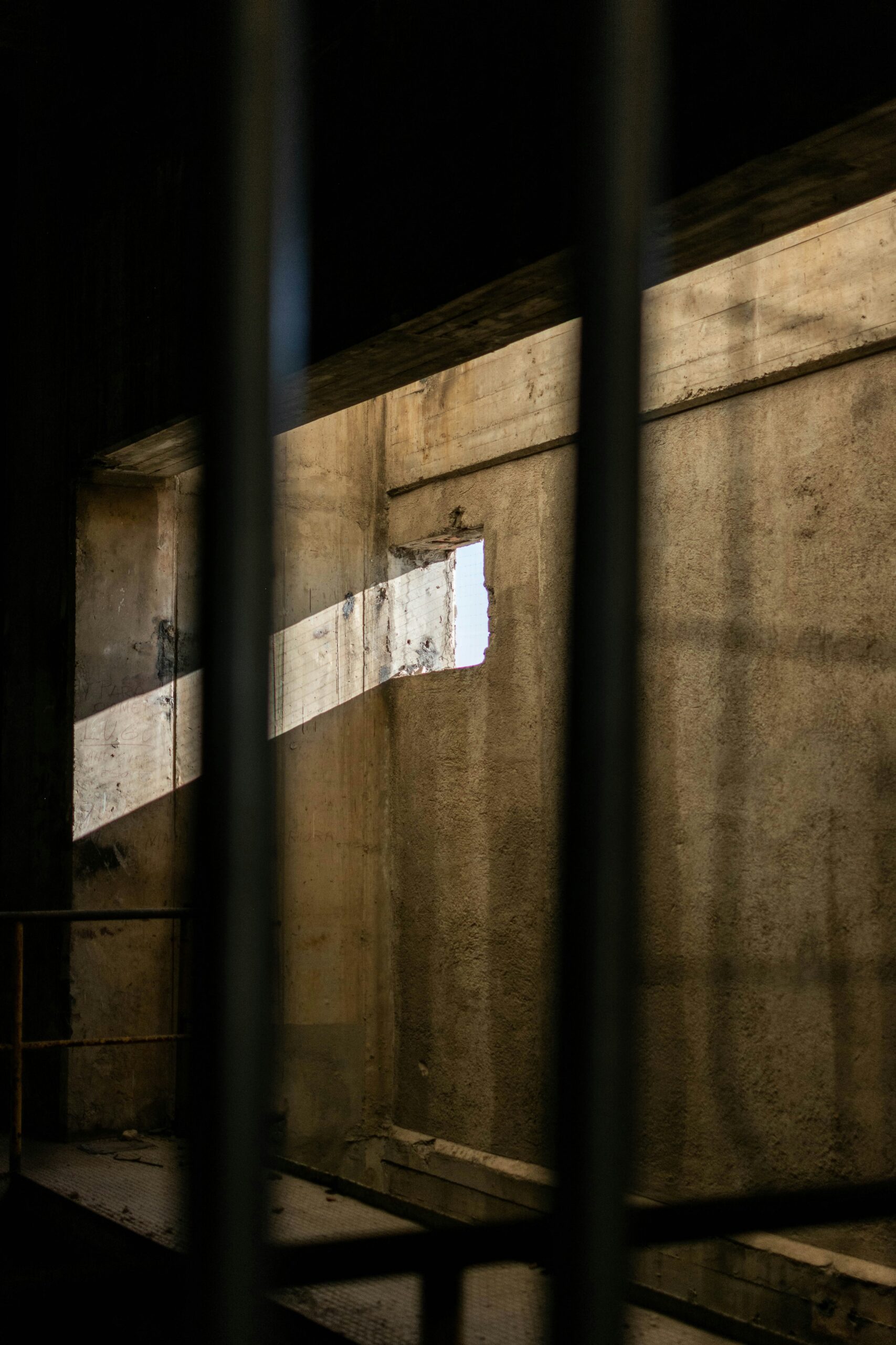 Shadows behind bars evoke the sense of being imprisoned