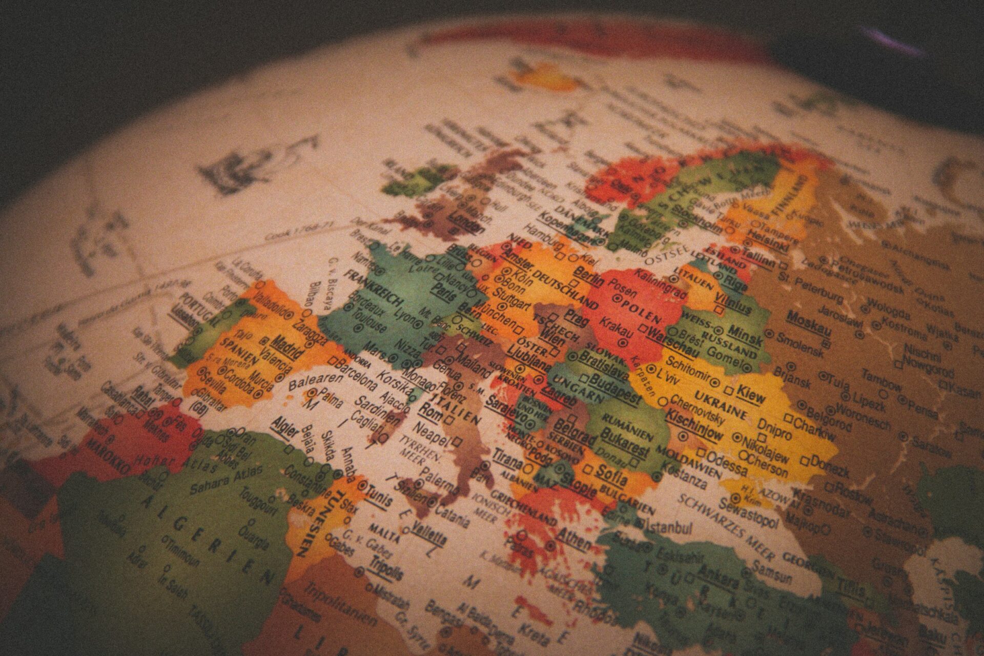 This photo shows a vintage globe with Europe in focus (Christian Lue via Unsplash)