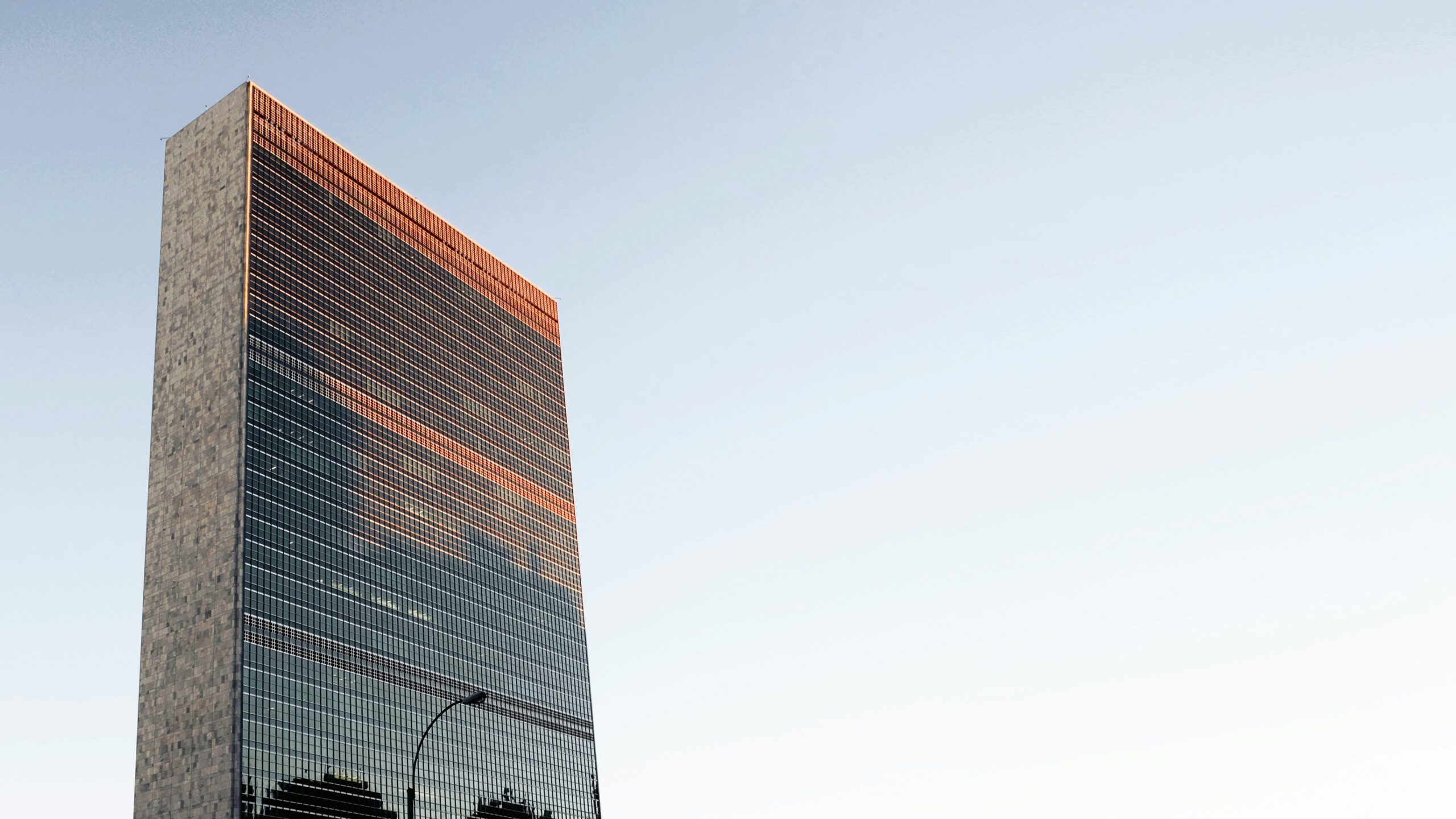 The sun sets over the United Nations headquarters in New York City, New York, published on June 16, 2016 (Daryan Shamkhali/Unsplash)