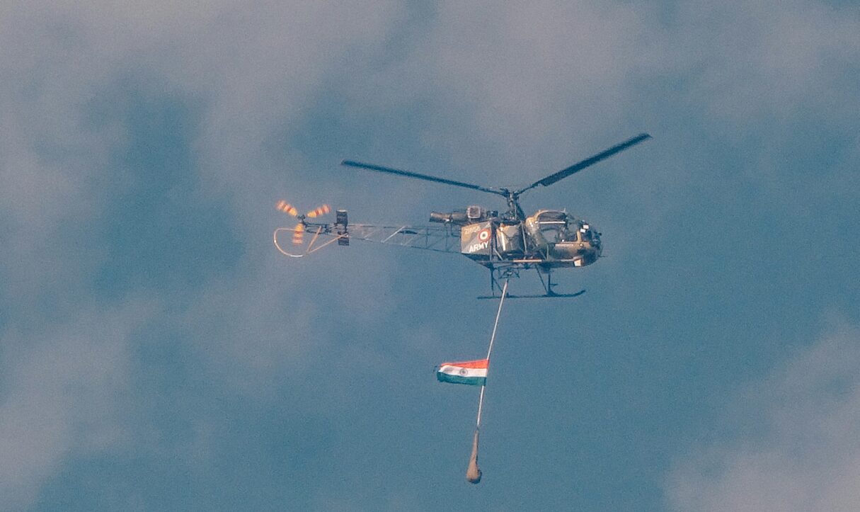 An Indian flag flies from a military helicopter in March 2025 (Dinesh Dixit/Unsplash)