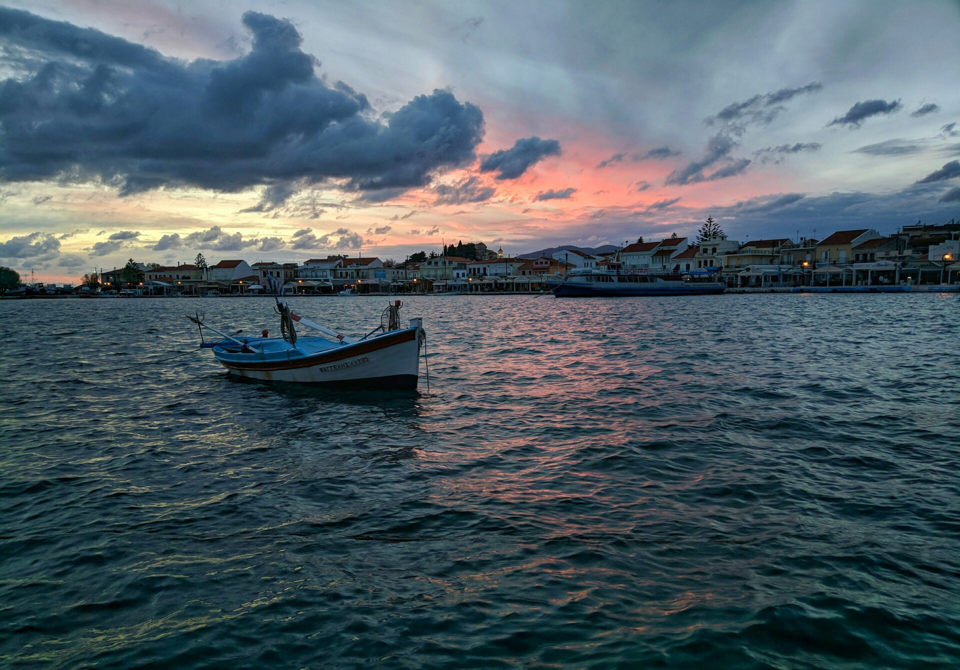 A stock photo shows a small boat in the waters off the island of Samos, Greece, in July 2019 (Fotis Fotopoulos/Unsplash)