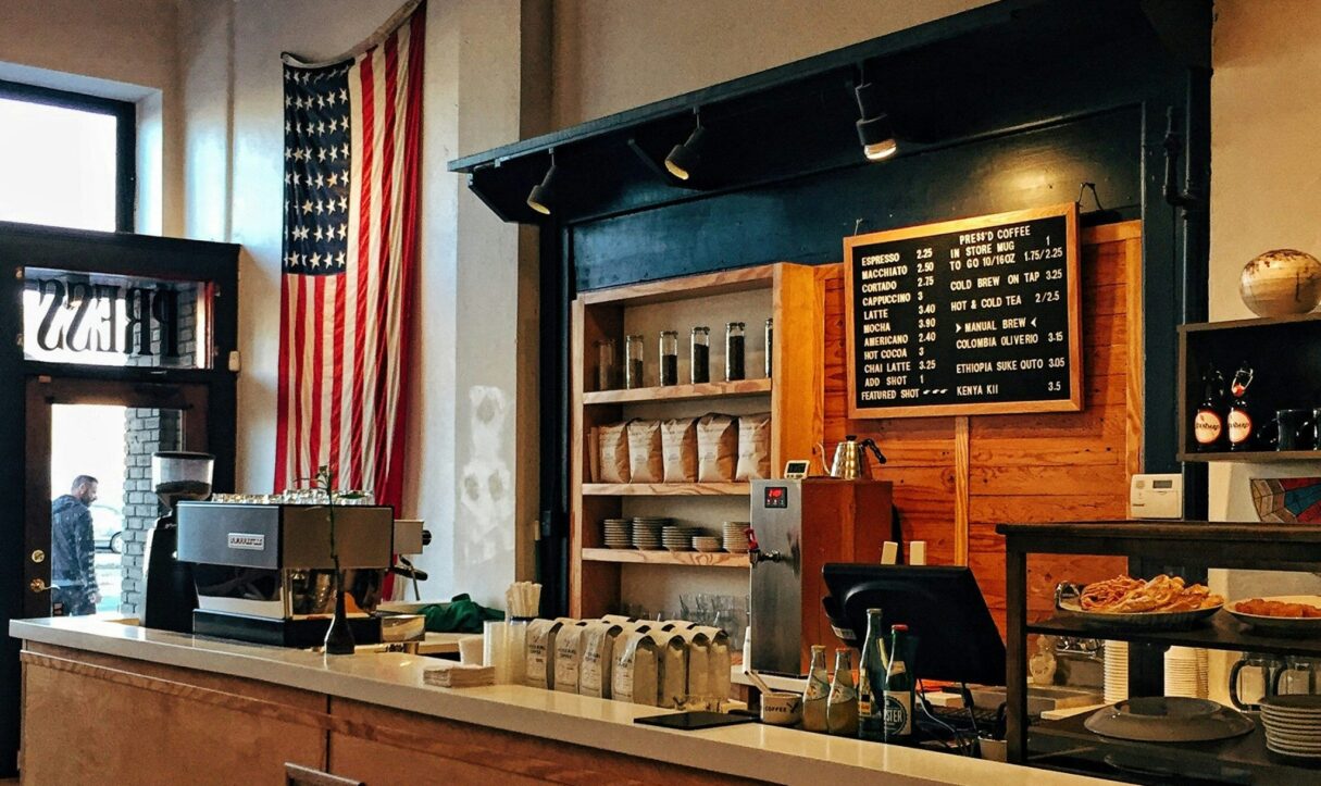 A coffee shop with an American flag on the wall.