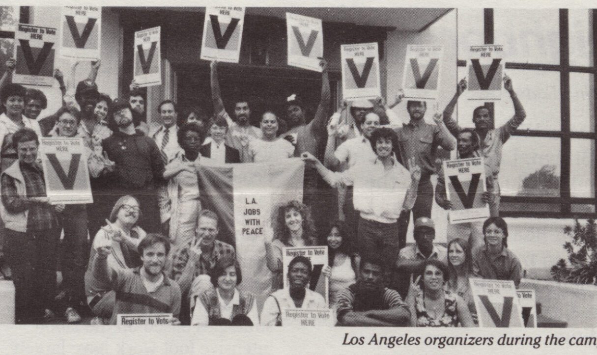 Activists with the 1986 Los Angeles Jobs with Peace campaign hold signs for Proposition V outside the International Ladies Garment Workers union hall on MacArthur Park. The building is now the UCLA James M. Lawson, Jr. Worker Justice Center, home of the UCLA Labor Center.