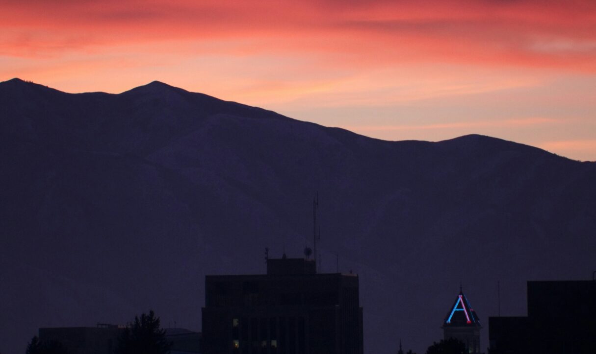 A photo captures sunset over the campus of Utah State University, published in February 2019 (Joshua Hoehne/Unsplash)