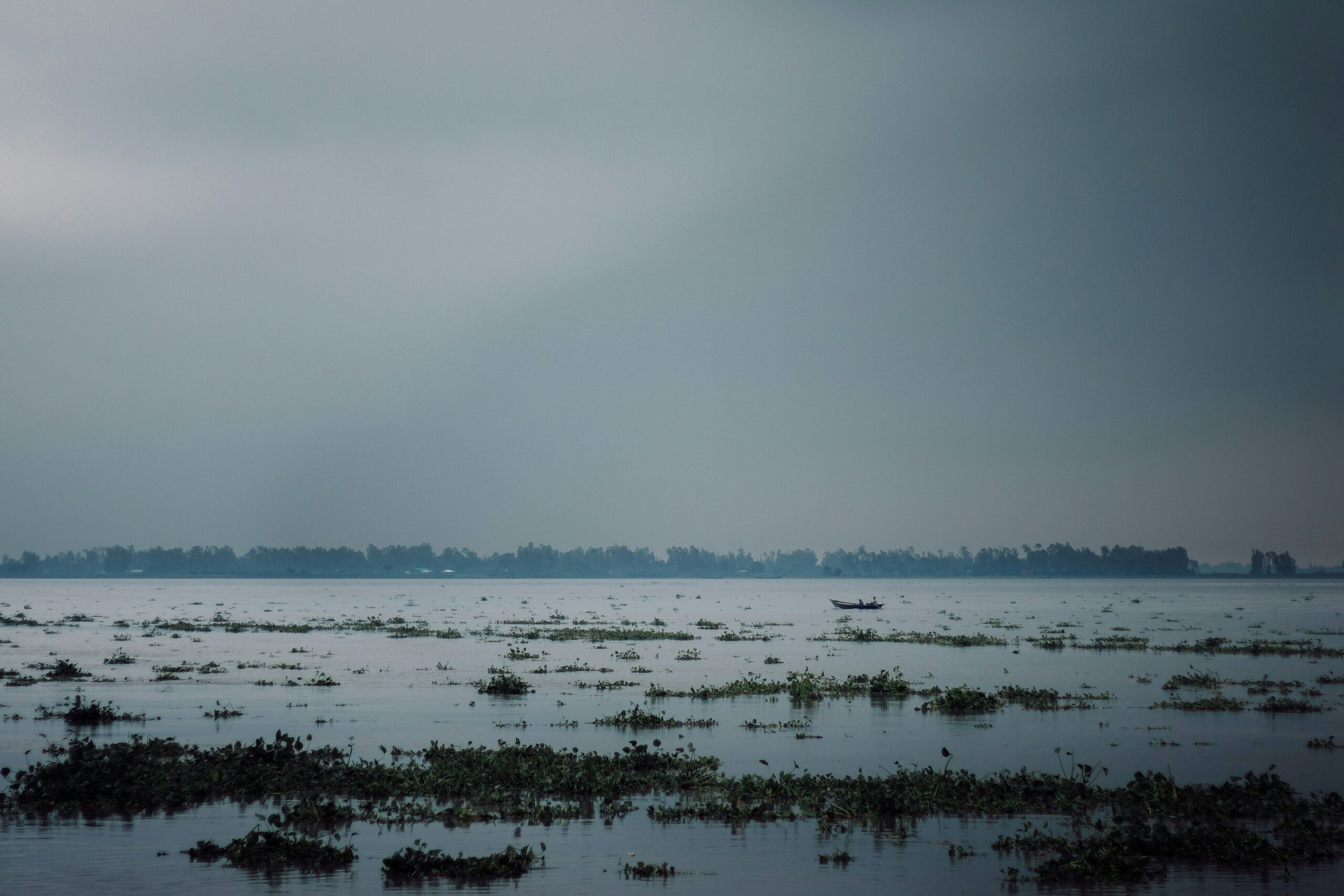 A photo shows dark clouds gathering near Chilmari, Bangladesh, in July 2024 (Kabiur Rahman Riyad/Unsplash)