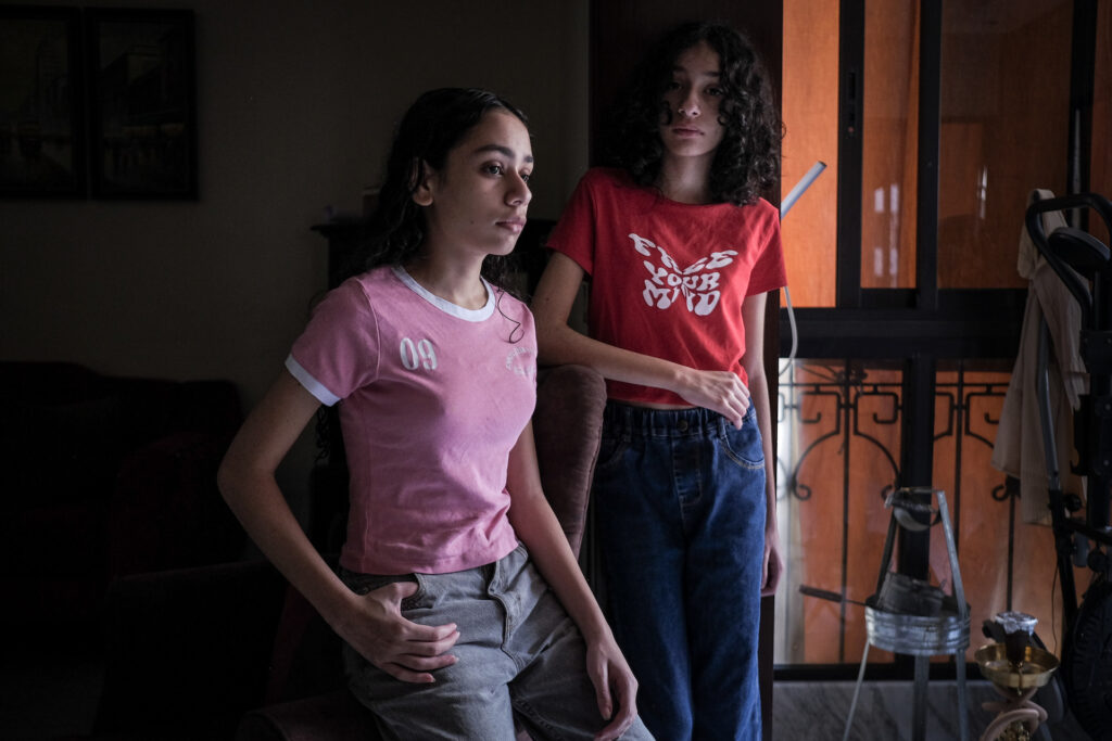 Fifteen-year-old twins Mariam and Marwa at home in a southern Beirut suburb, shortly after Israel’s deadly pager attack killed and injured dozens (João Sousa)