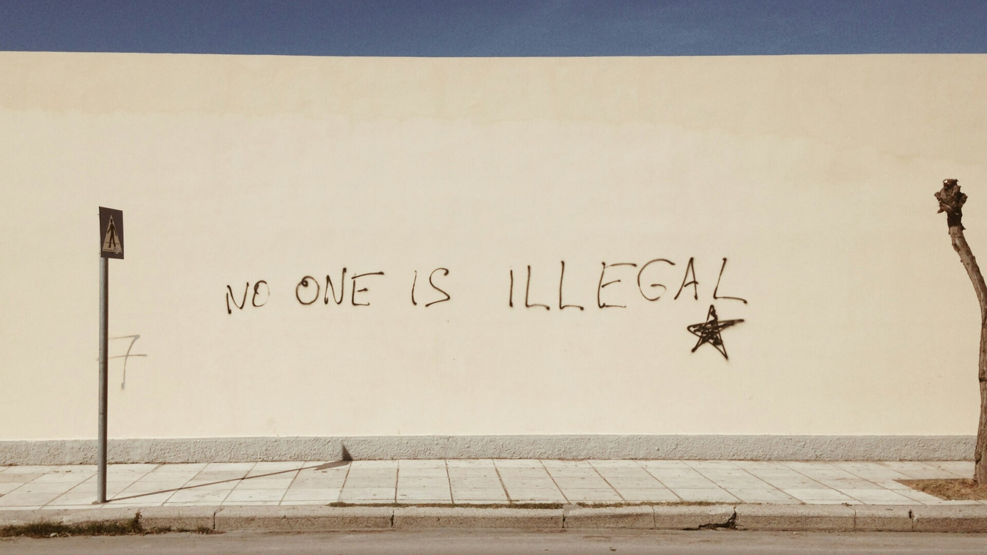 Graffiti on the Greek island of Kos "no one is illegal," photographed in November 2018 (Miko Guziuk via Unsplash)