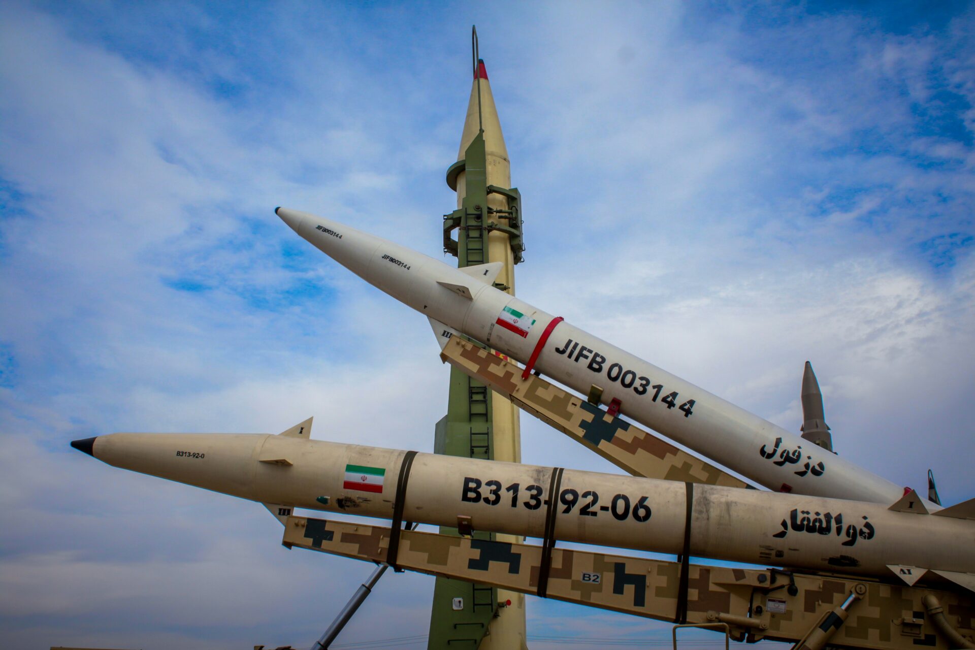 A photo shows Iranian flags on missiles, January 2025 (Moslem Daneshzadeh/Unsplash)