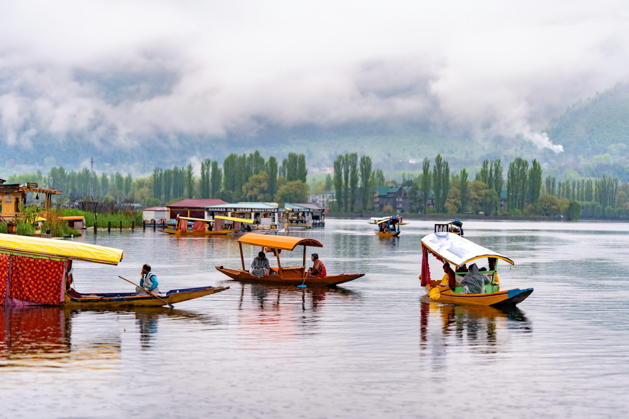 a group of boats floating on top of a lake in Kashmir.