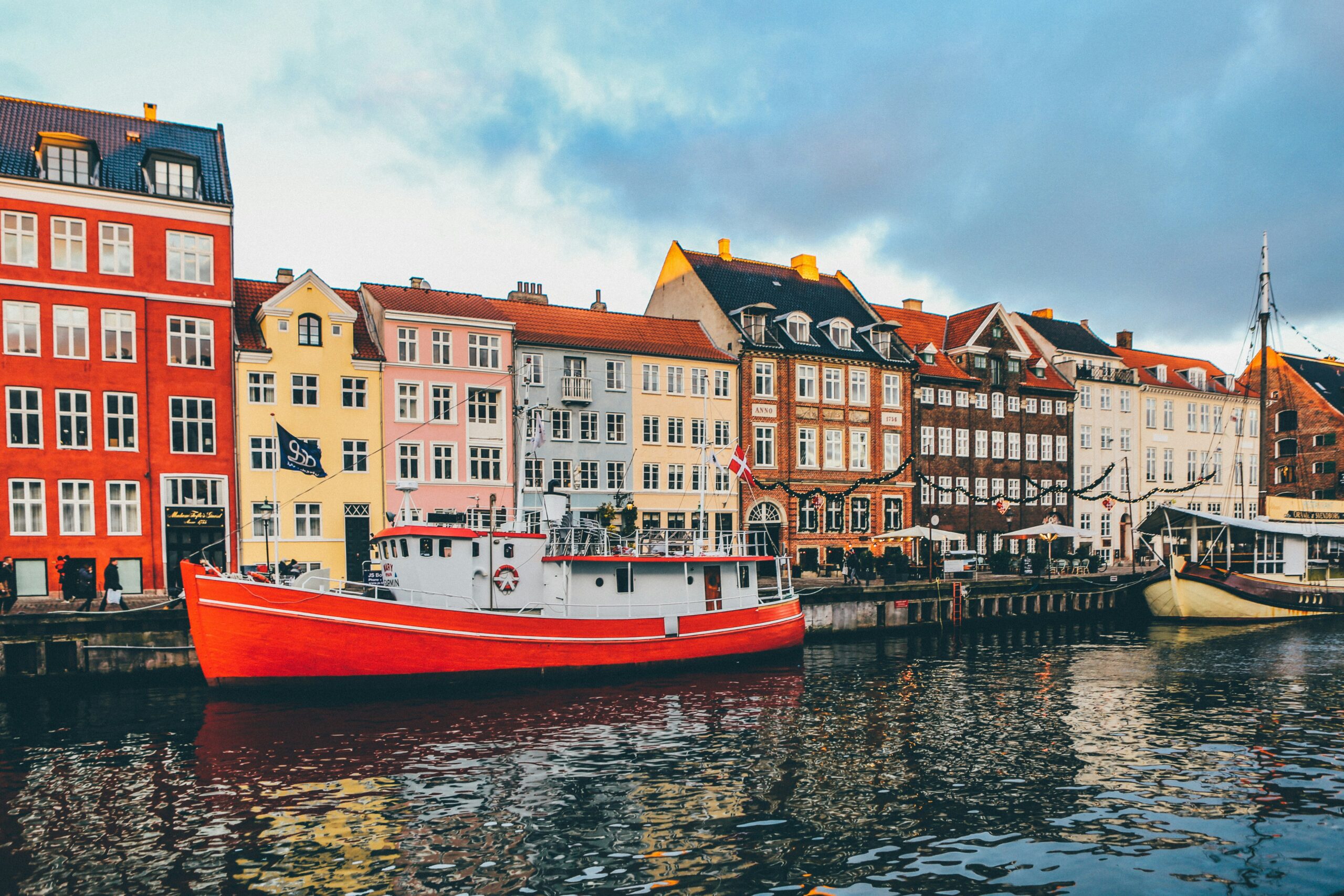 A photo shows homes and buildings on the waterfront in Nyhavn, Denmark (Nick Karvounis via Unsplash)