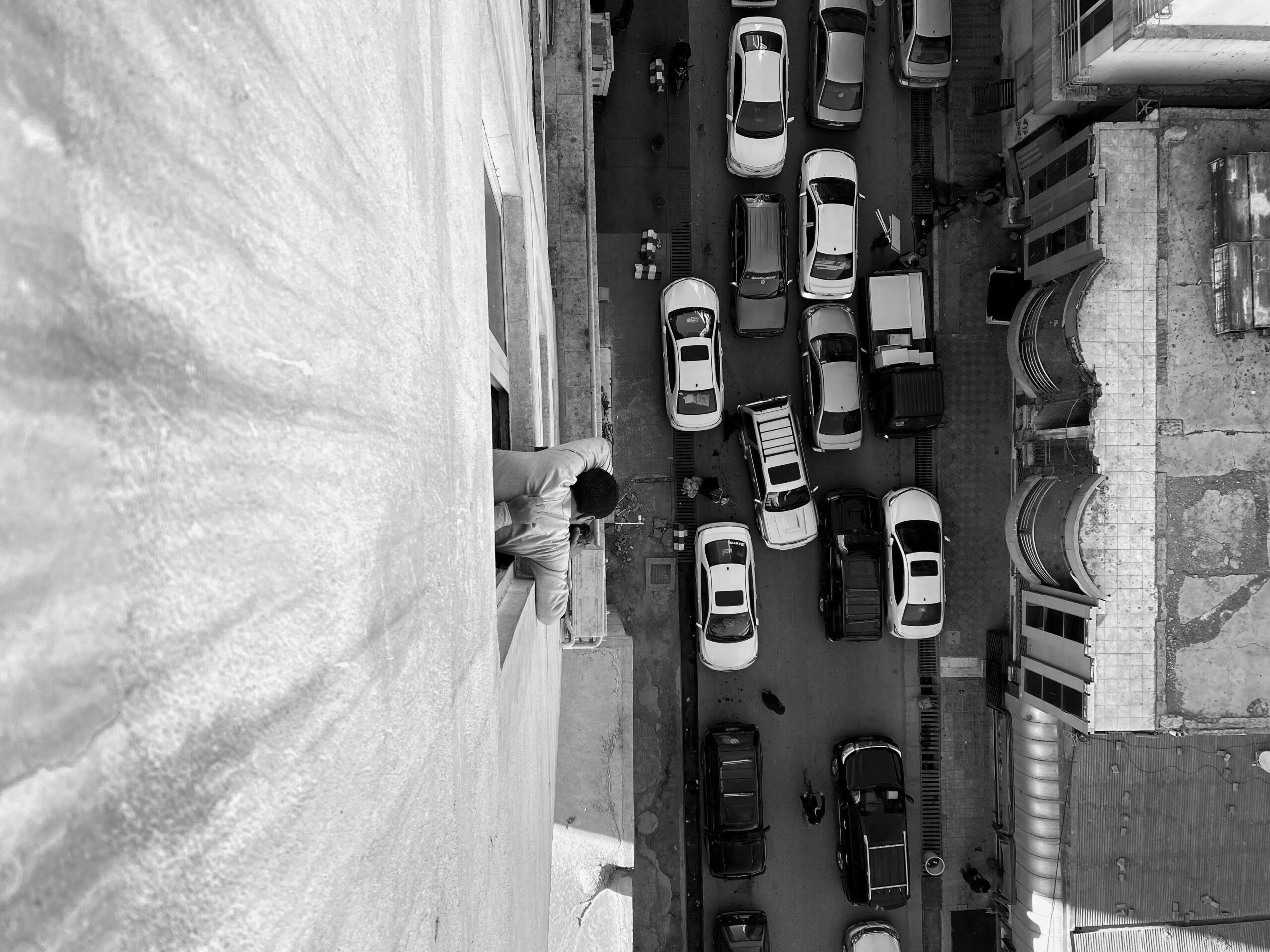 a person looks out over a crowded street in kabul