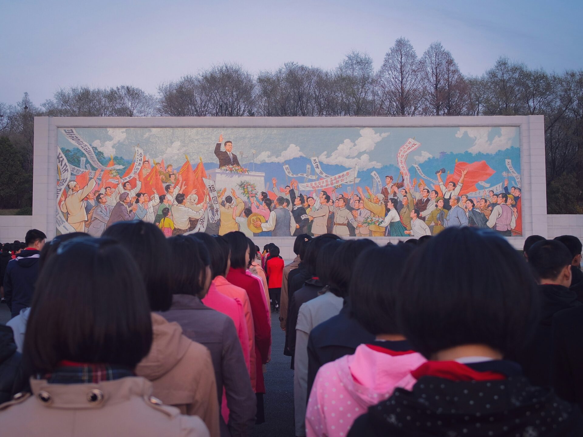 Children line up in front of a mural in Pyongyang, North Korea (Thomas Evans via Unsplash)