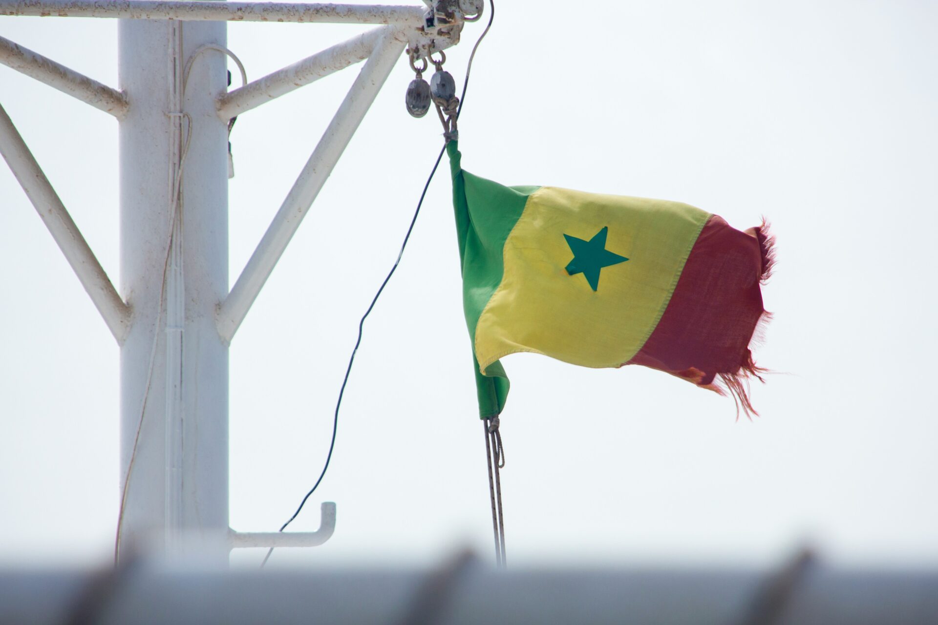 A Senegalese flag hangs from a boat in Dakar (Victor Rutka via Unsplash)